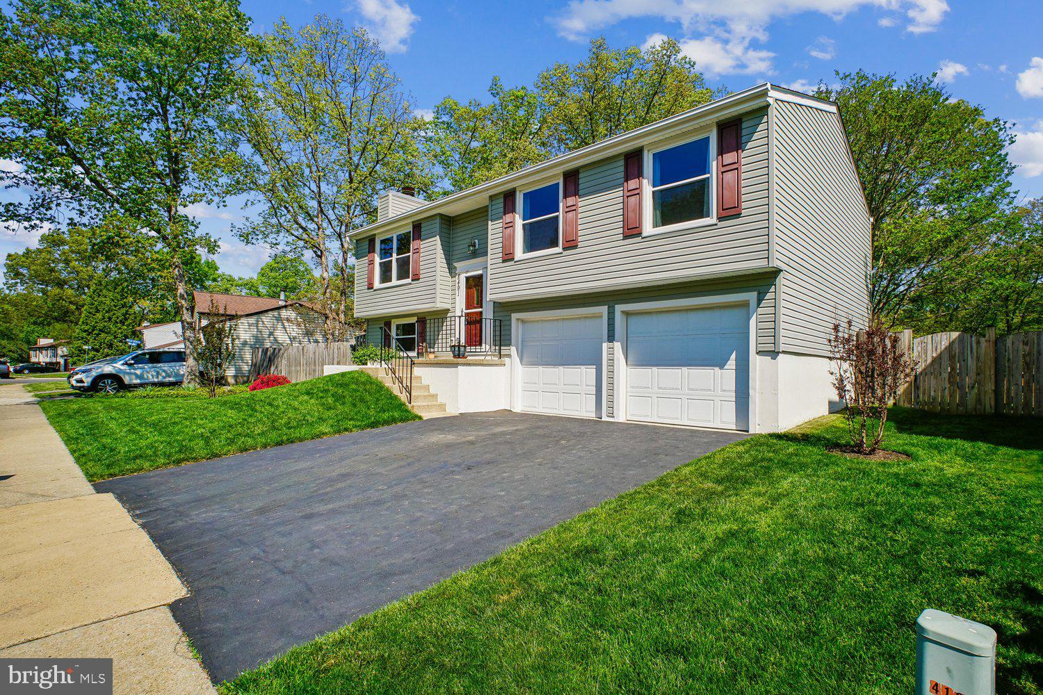 8491 Rippled Creek Court Springfield, VA 22153 - Photo 4 of 40 a front view of a house with a yard and garage