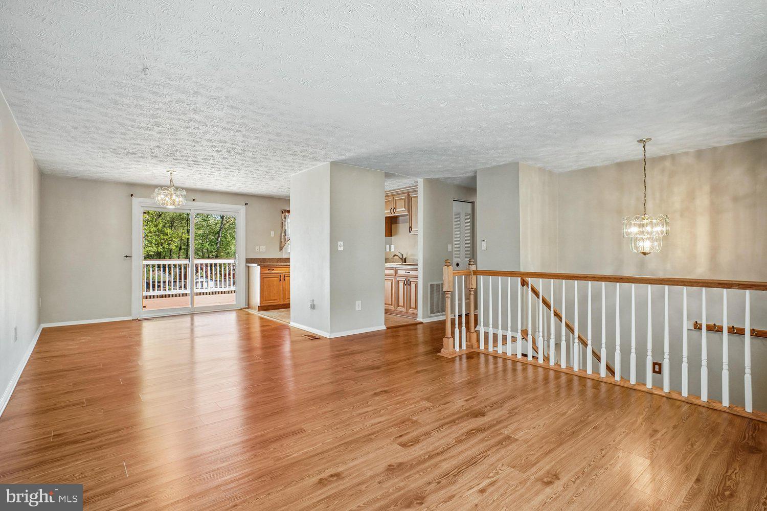 8491 Rippled Creek Court Springfield, VA 22153 - Photo 7 of 40 a view of an empty room with wooden floor and a window