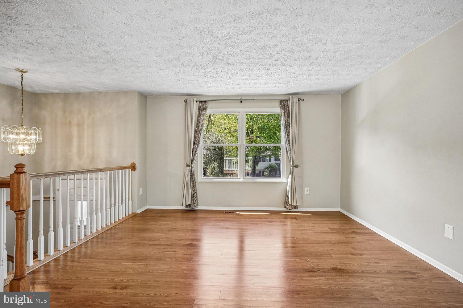 8491 Rippled Creek Court Springfield, VA 22153 - Photo 8 of 40 a view of empty room with wooden floor and fan