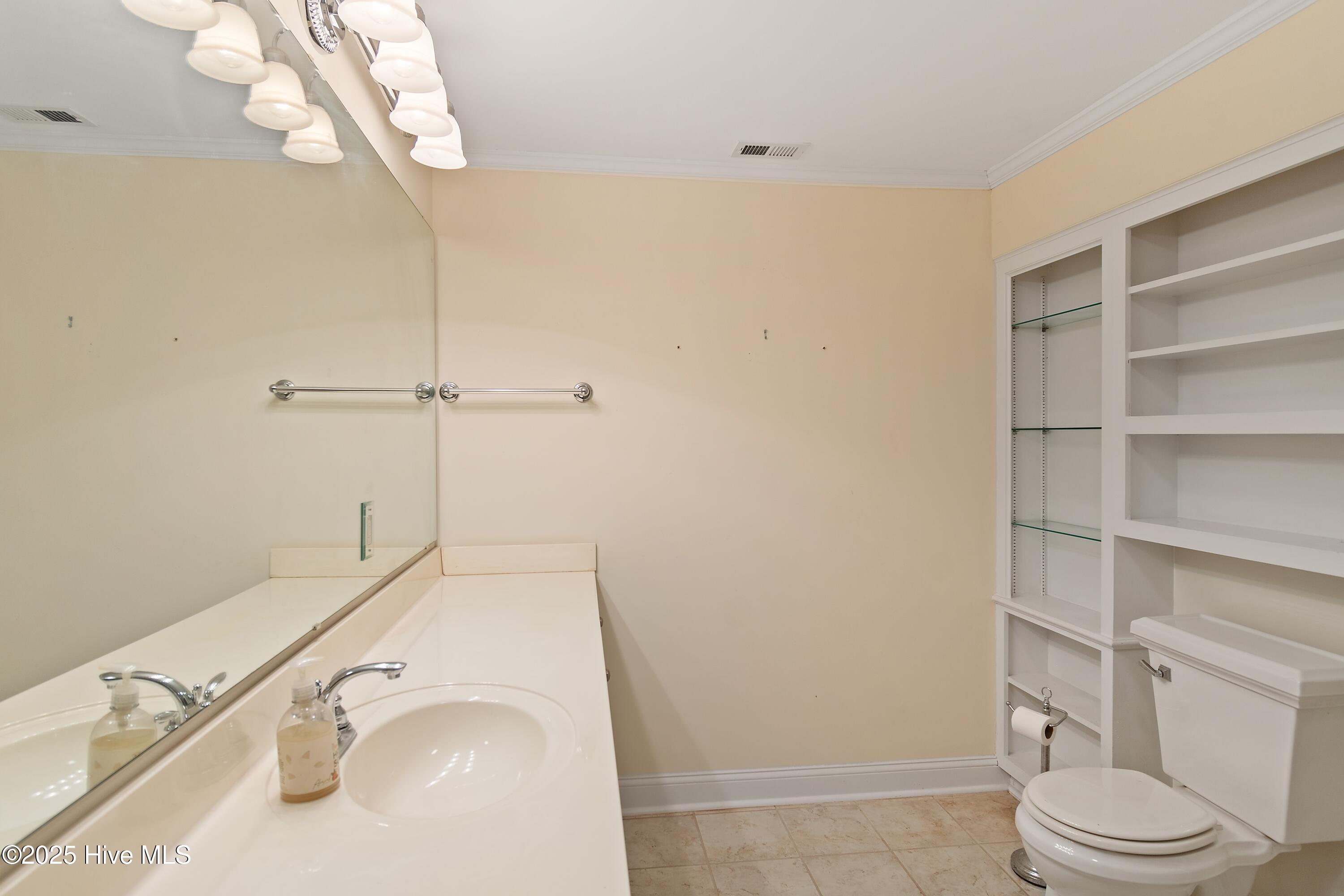 6777 Roberta Road Southwest Ocean Isle Beach, NC 28469 - Photo 41 of 89 2nd Floor Bath with glass display shelves and Wooden shelves.