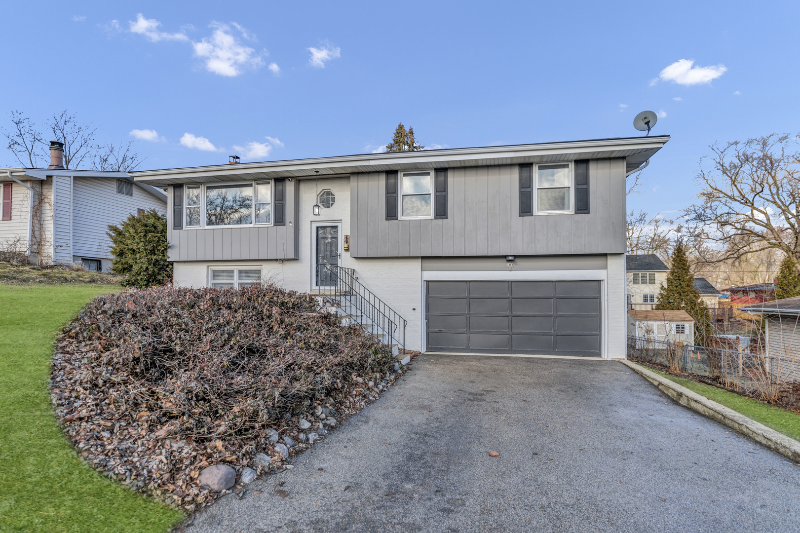 103 Fir Street Lake In The Hills, IL 60156 - Photo 2 of 31 a front view of a house with a yard and garage