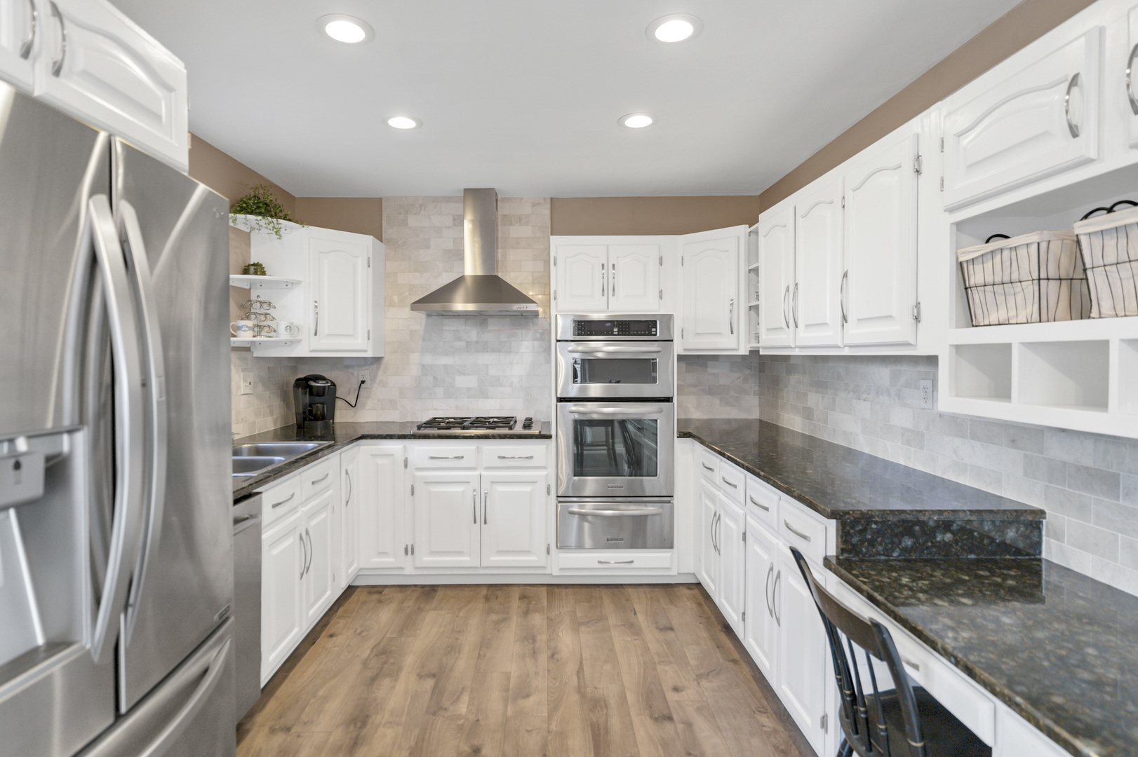103 Fir Street Lake In The Hills, IL 60156 - Photo 7 of 31 a kitchen with stainless steel appliances granite countertop a stove a sink dishwasher a refrigerator white cabinets and wooden floor