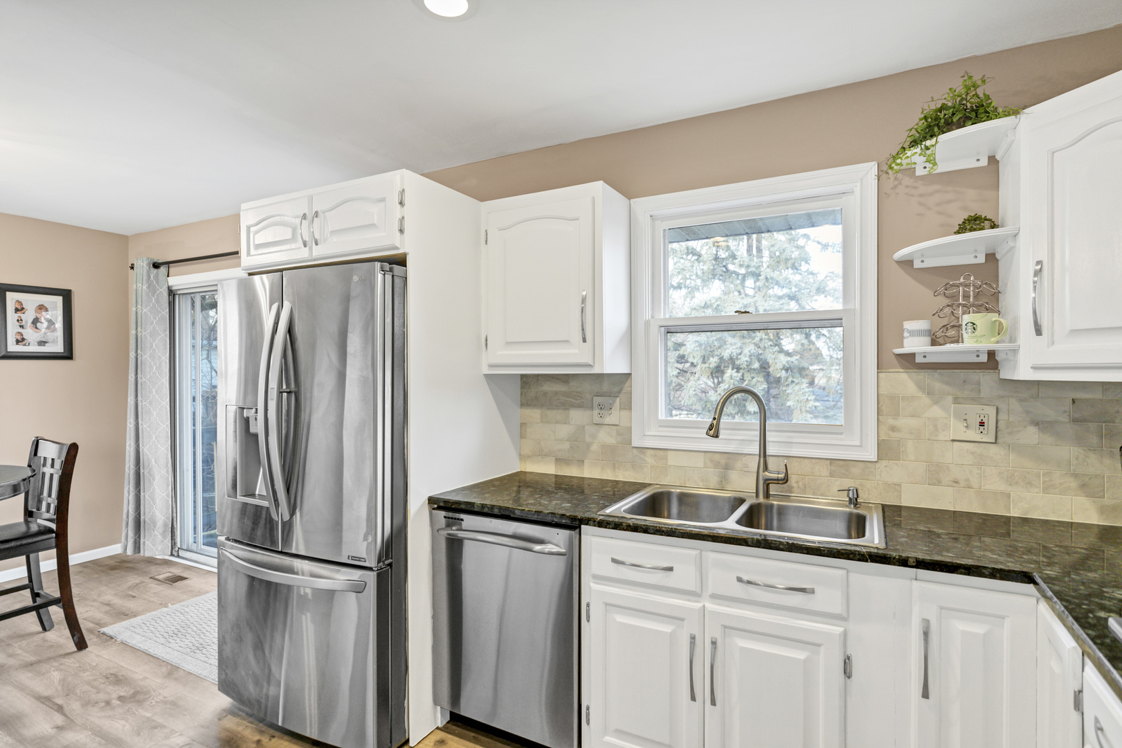 103 Fir Street Lake In The Hills, IL 60156 - Photo 9 of 31 a kitchen with stainless steel appliances granite countertop a refrigerator and a sink