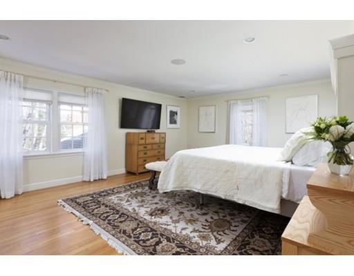 7 Deer Run Road Lincoln, MA 01773 - Photo 14 of 30 a spacious bedroom with a bed a fireplace and a flat tv screen