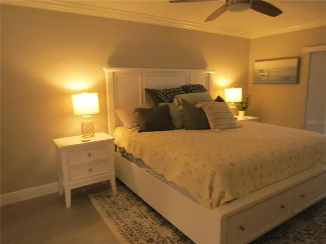 a large bed sitting in a bedroom next to a lamp