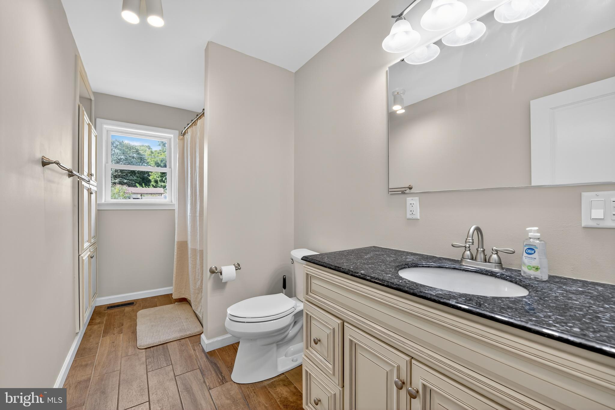 1 Spring Avenue Temple, PA 19560 - Photo 14 of 34 a bathroom with a granite countertop toilet sink and mirror
