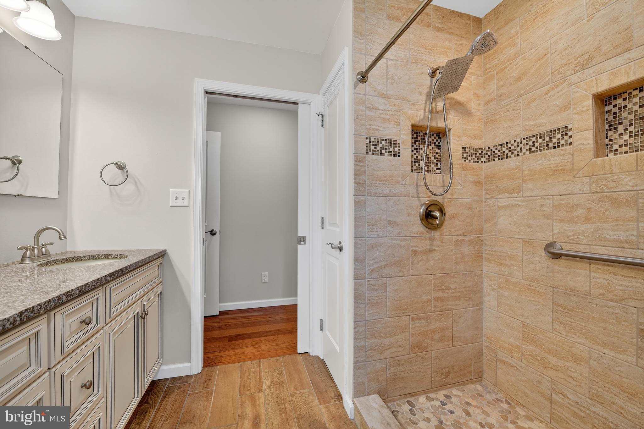 1 Spring Avenue Temple, PA 19560 - Photo 18 of 34 a bathroom with a granite countertop sink a shower and a mirror