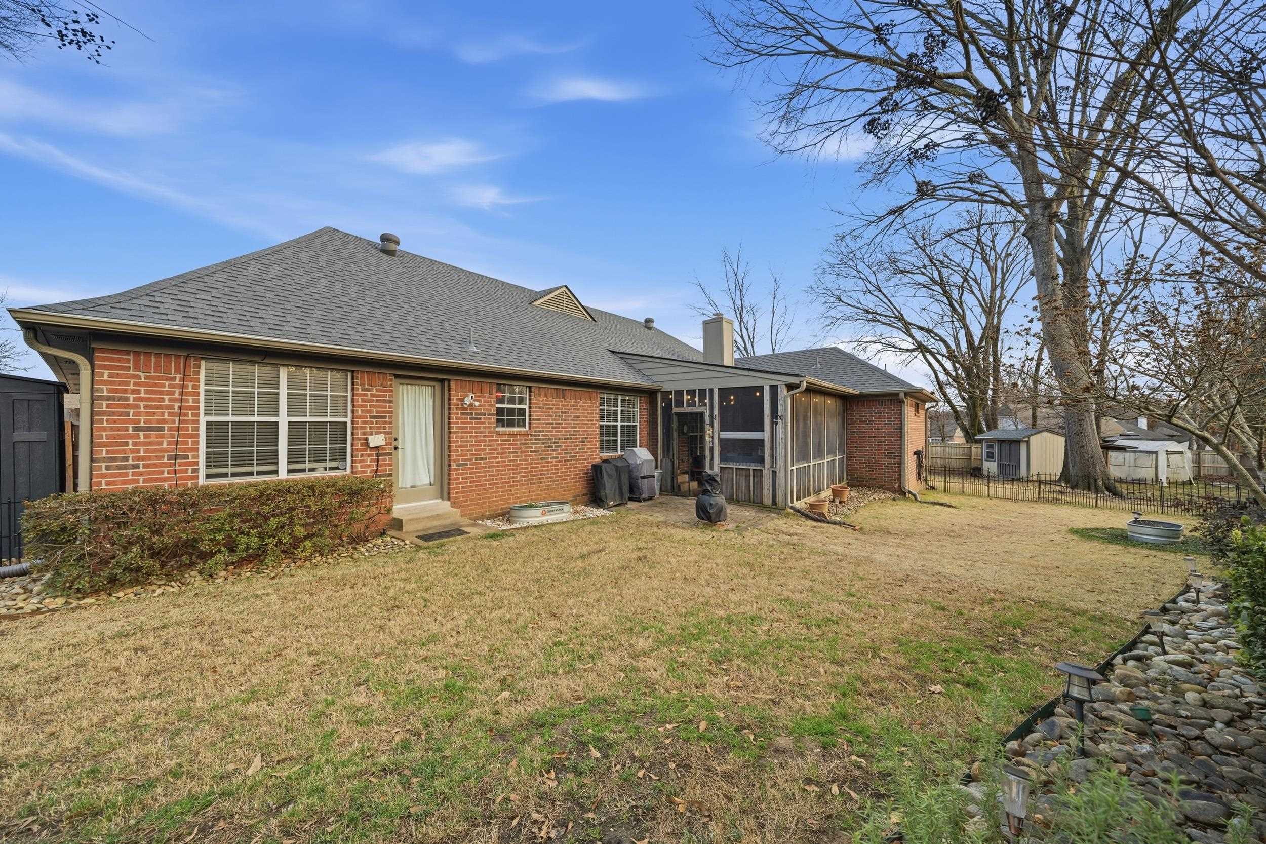 307 John Cove Collierville, TN 38017 - Photo 11 of 25 Rear view of house with brick siding, roof with shingles, a chimney, and entry steps