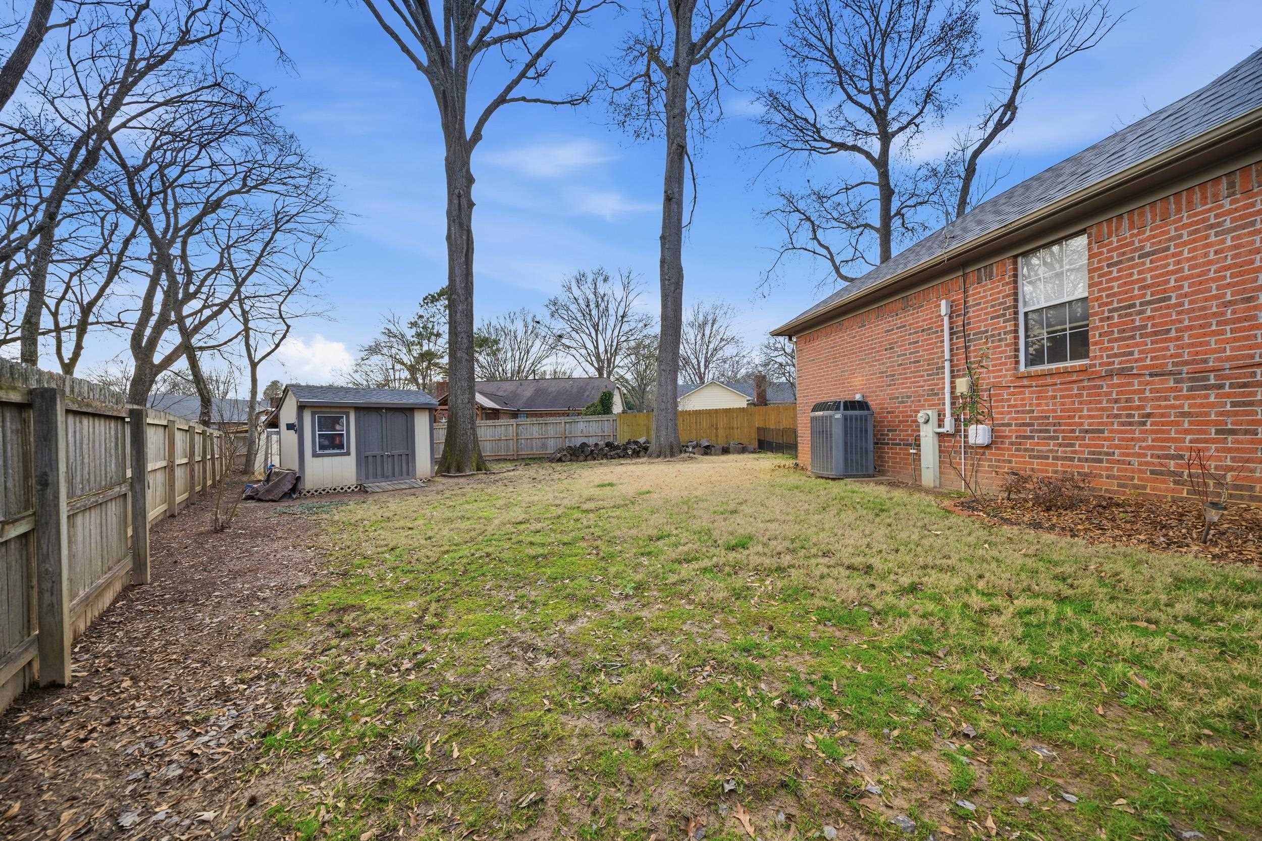 307 John Cove Collierville, TN 38017 - Photo 14 of 25 Fenced backyard featuring a storage shed