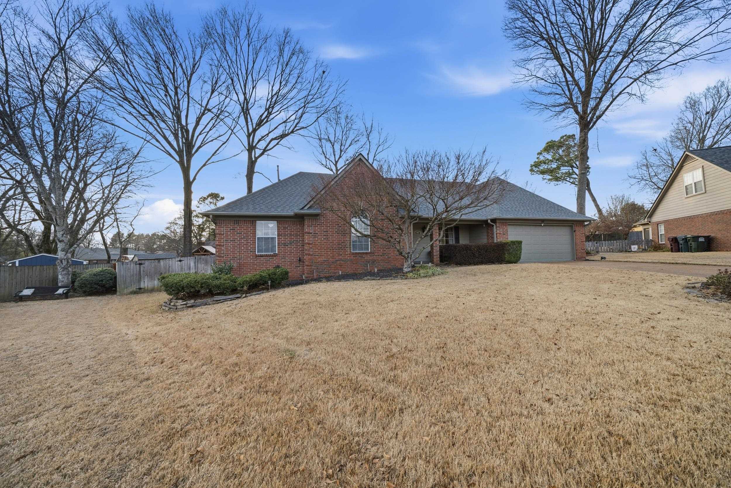 307 John Cove Collierville, TN 38017 - Photo 17 of 25 Ranch-style house with brick siding, a garage, and driveway