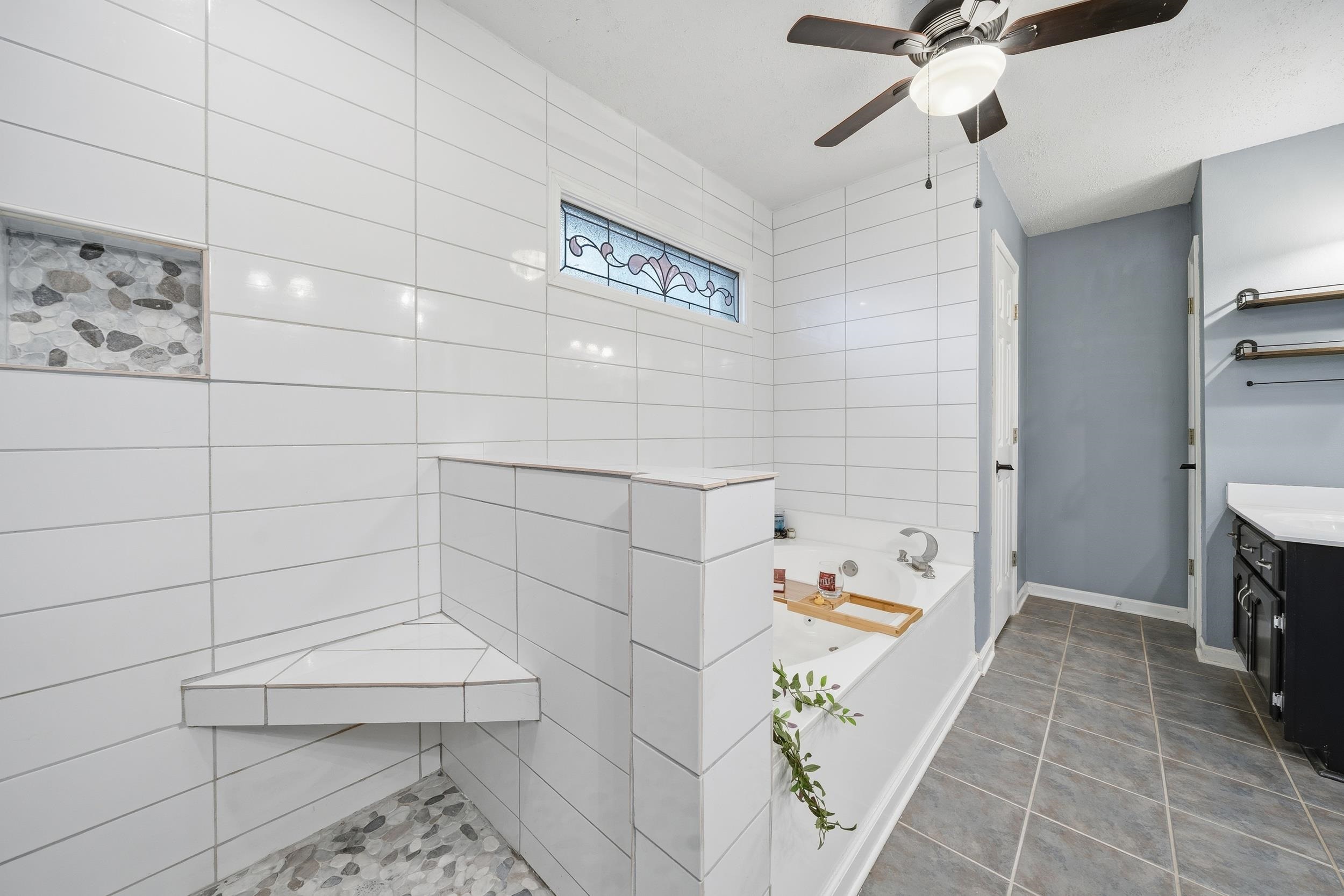 307 John Cove Collierville, TN 38017 - Photo 25 of 25 Bathroom with a bath, vanity, a ceiling fan, dark tile patterned flooring, and a walk in shower