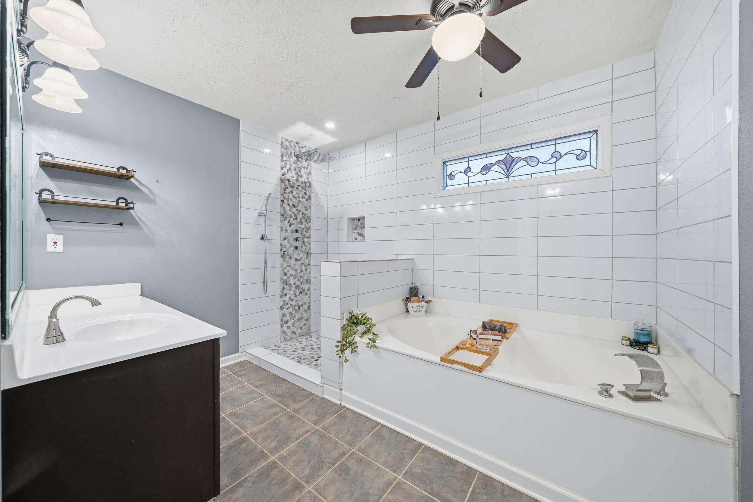 307 John Cove Collierville, TN 38017 - Photo 6 of 25 Full bathroom featuring a garden tub, tiled shower, vanity, ceiling fan, and dark tile patterned floors