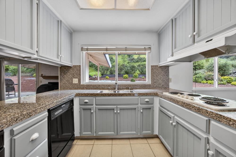 4071 Silver Street Rocklin, CA 95677 - Photo 11 of 70 a kitchen with a sink stove top oven and cabinets