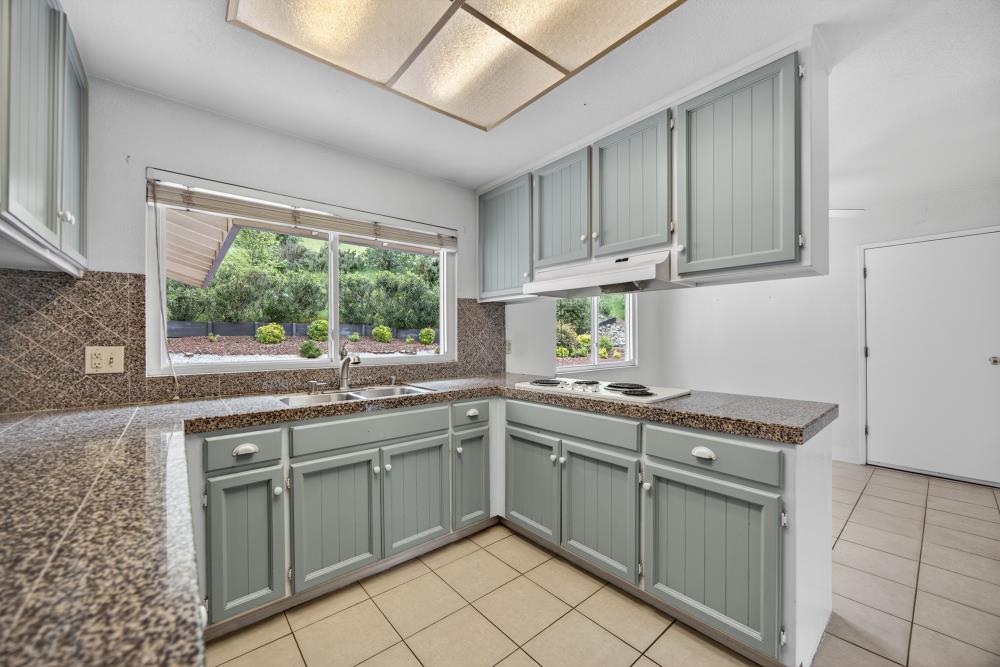 4071 Silver Street Rocklin, CA 95677 - Photo 13 of 70 a kitchen with a sink stove and cabinets