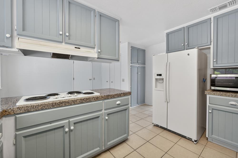 4071 Silver Street Rocklin, CA 95677 - Photo 14 of 70 a kitchen with granite countertop cabinets and steel stainless steel appliances