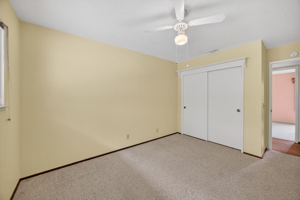 4071 Silver Street Rocklin, CA 95677 - Photo 30 of 70 an empty room with a ceiling fan and a window