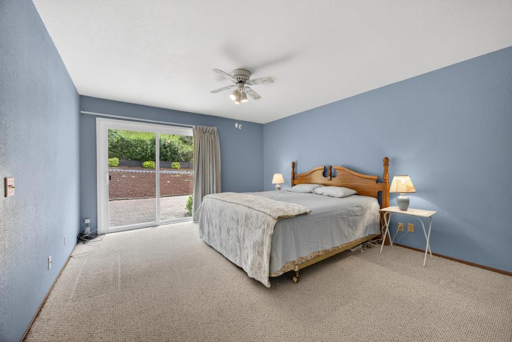 4071 Silver Street Rocklin, CA 95677 - Photo 32 of 70 a spacious bedroom with a bed and a chandelier