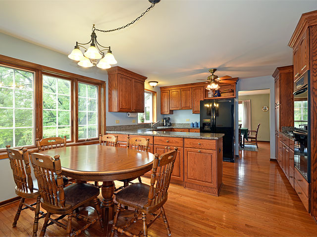 587 Scots Court Inverness, IL 60067 - Photo 3 of 18 a large kitchen with a table and chairs