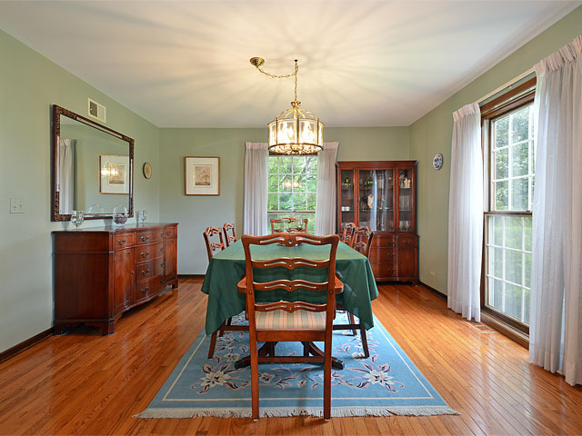 587 Scots Court Inverness, IL 60067 - Photo 5 of 18 a dining room with furniture a chandelier and wooden floor