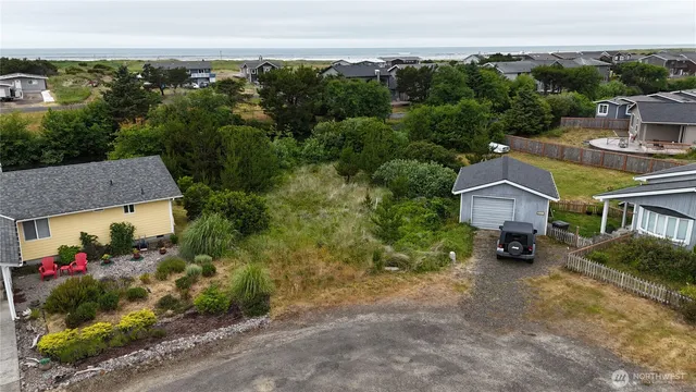 an aerial view of a house with a yard and lake view
