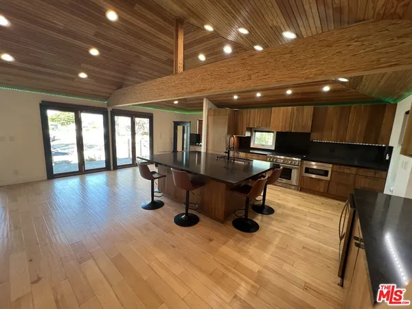 a kitchen with a table chairs refrigerator and microwave