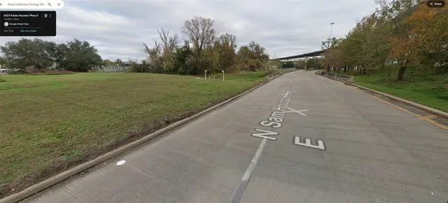a view of a street with a trees in the background
