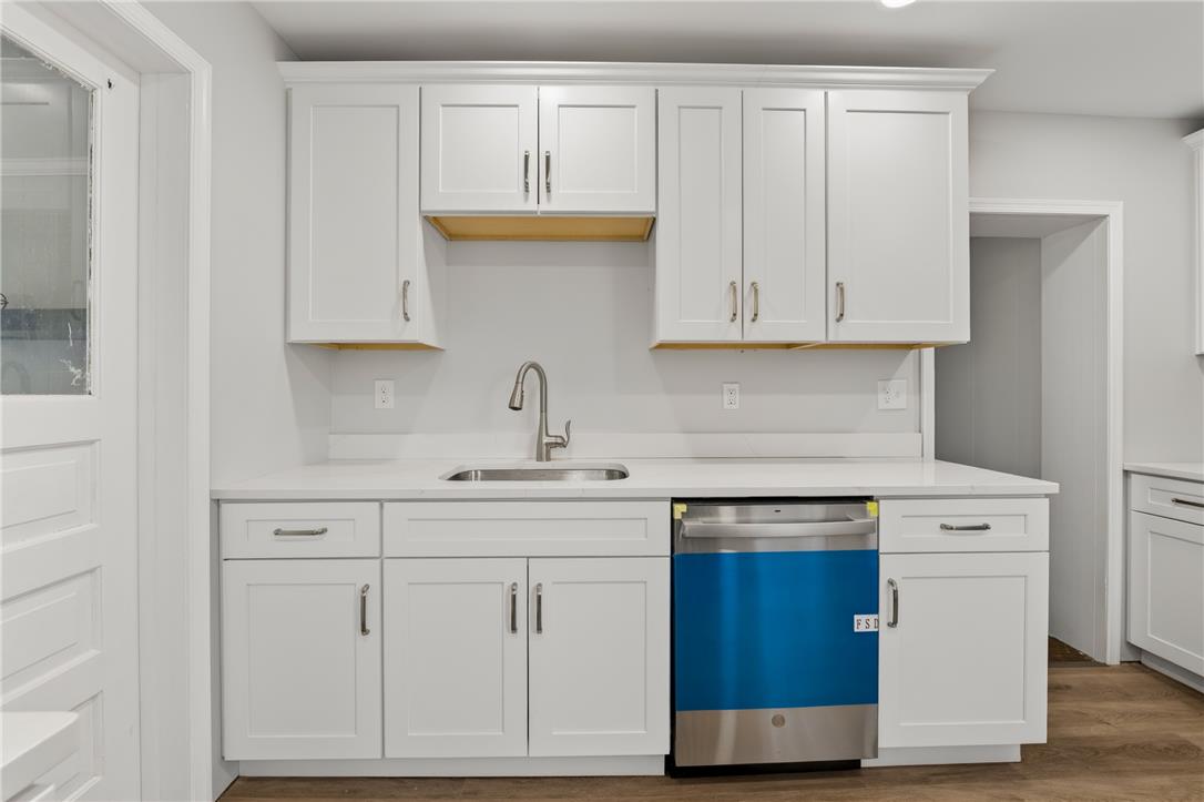 65 2nd Street Slatington, PA 18080 - Photo 20 of 46 This newly updated kitchen space features sleek white cabinetry and a new stainless steel dishwasher, ready for culinary endeavors.