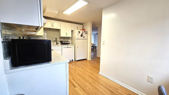 a kitchen with stainless steel appliances a refrigerator and a stove top oven