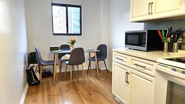 a kitchen with stainless steel appliances a refrigerator and a stove top oven