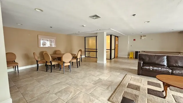 a living room with furniture and a dining table