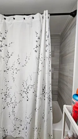 a bathroom with a shower curtain