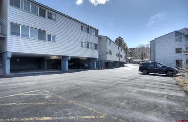 a view of a house with a yard and garage