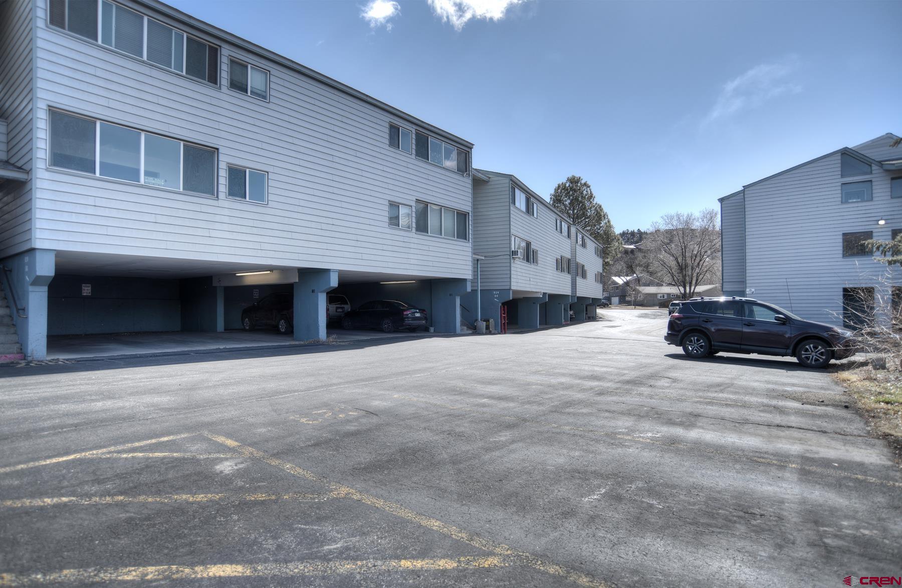 a view of a house with a yard and garage