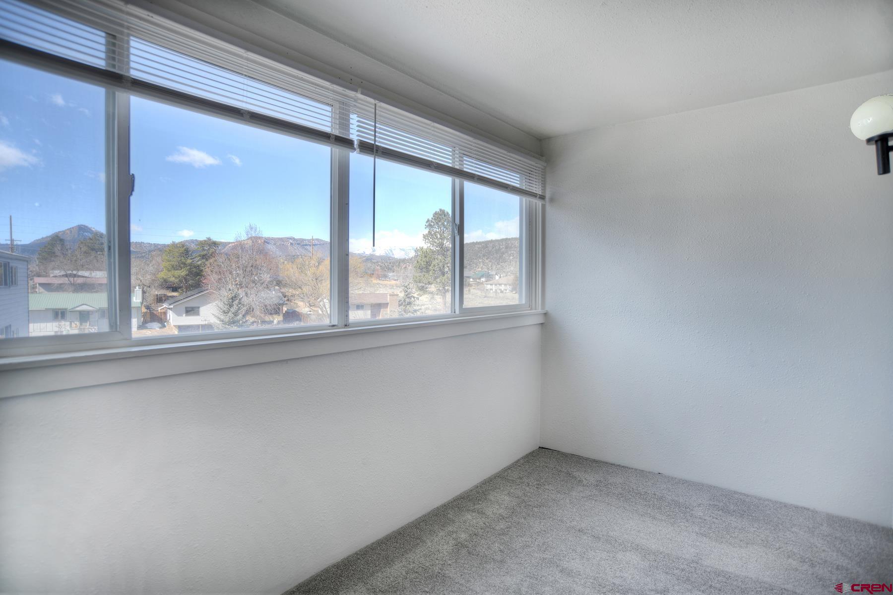 1135 Florida Road, Unit C27 Durango, CO 81301 - Photo 3 of 16 an empty room with a large window