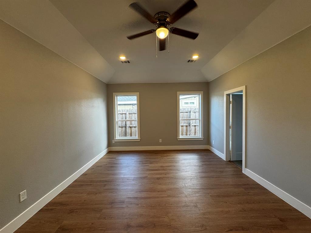 2533 Jonesboro Avenue Dallas, TX 75228 - Photo 11 of 27 a view of an empty room with window and wooden floor