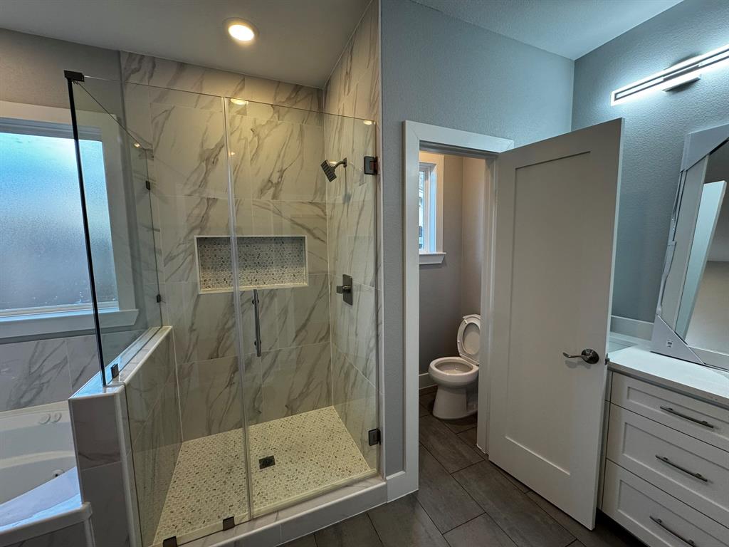 2533 Jonesboro Avenue Dallas, TX 75228 - Photo 12 of 27 a bathroom with a glass door shower