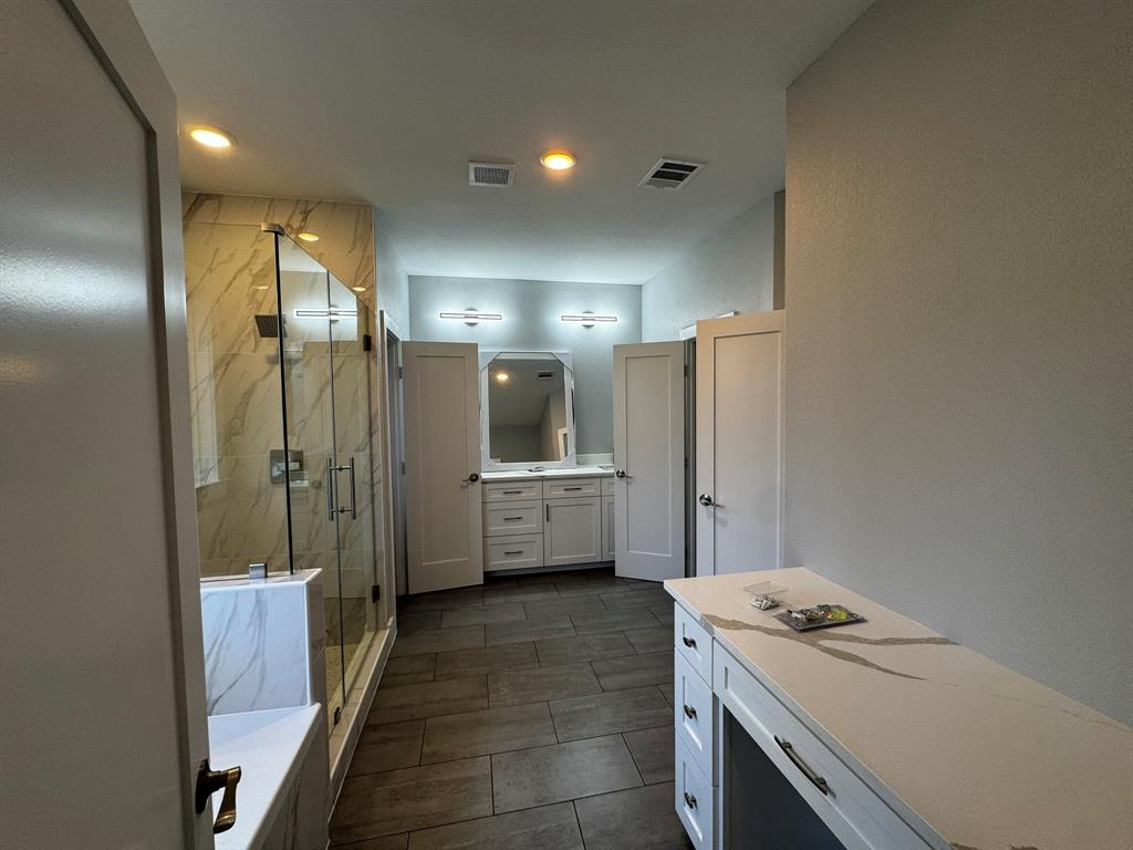 2533 Jonesboro Avenue Dallas, TX 75228 - Photo 14 of 27 a bathroom with a double vanity sink toilet and shower
