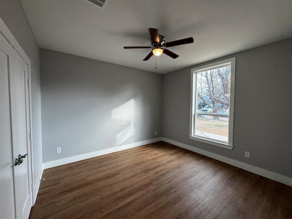 2533 Jonesboro Avenue Dallas, TX 75228 - Photo 18 of 27 a view of an empty room with wooden floor and a window