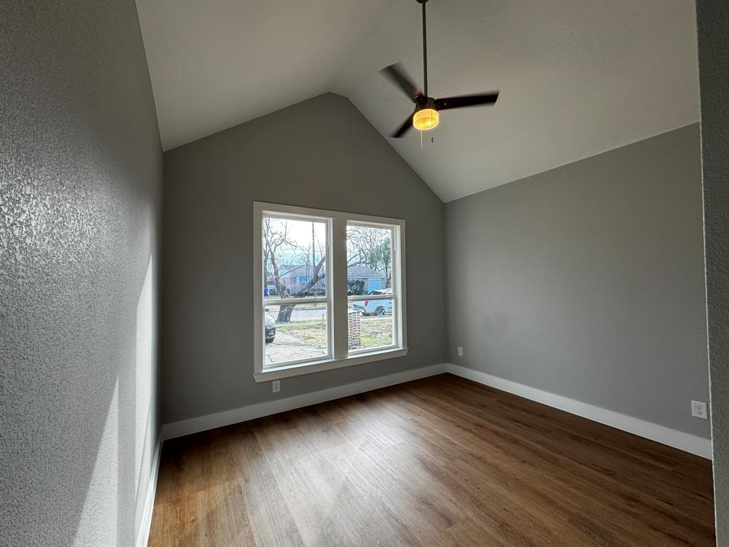 2533 Jonesboro Avenue Dallas, TX 75228 - Photo 19 of 27 a view of an empty room with wooden floor and a window