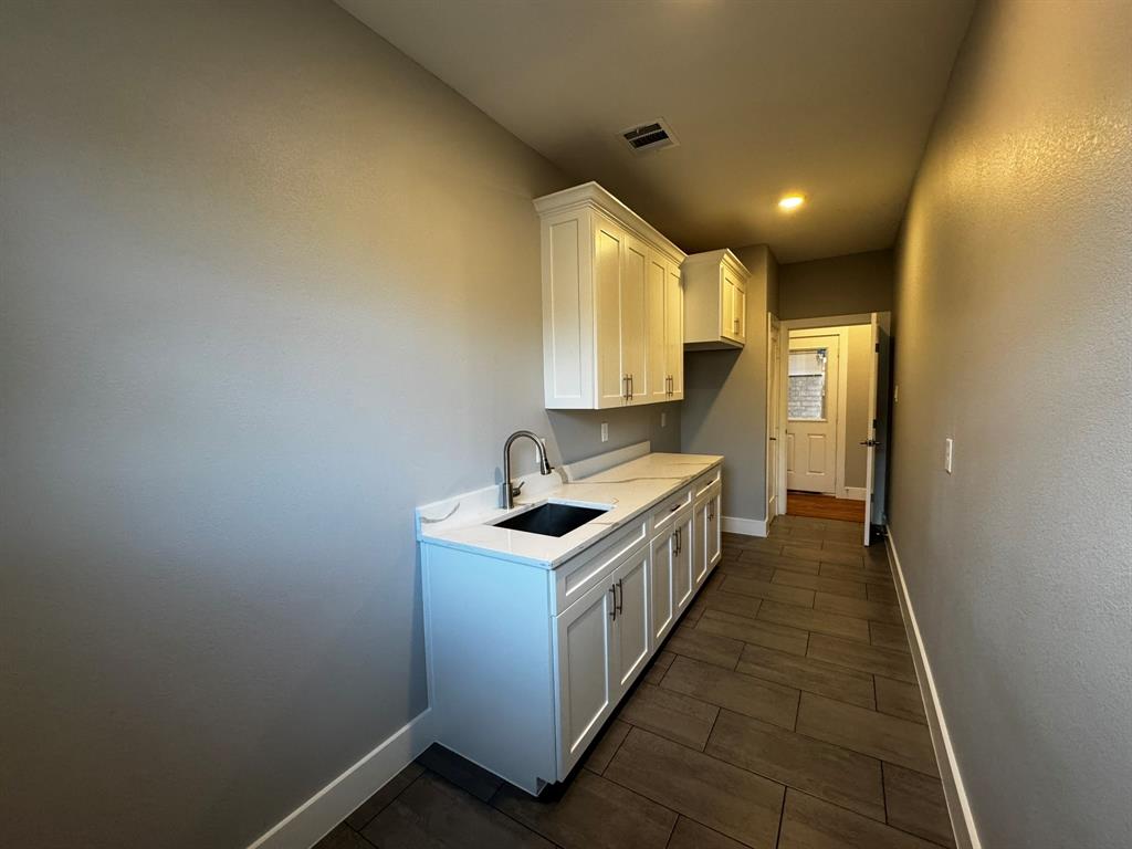 2533 Jonesboro Avenue Dallas, TX 75228 - Photo 22 of 27 a kitchen with a stove and a sink