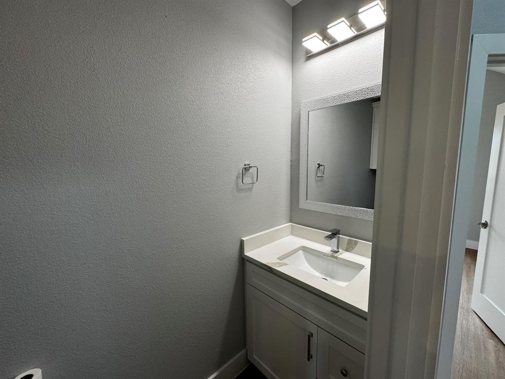 2533 Jonesboro Avenue Dallas, TX 75228 - Photo 24 of 27 a bathroom with a sink toilet and vanity