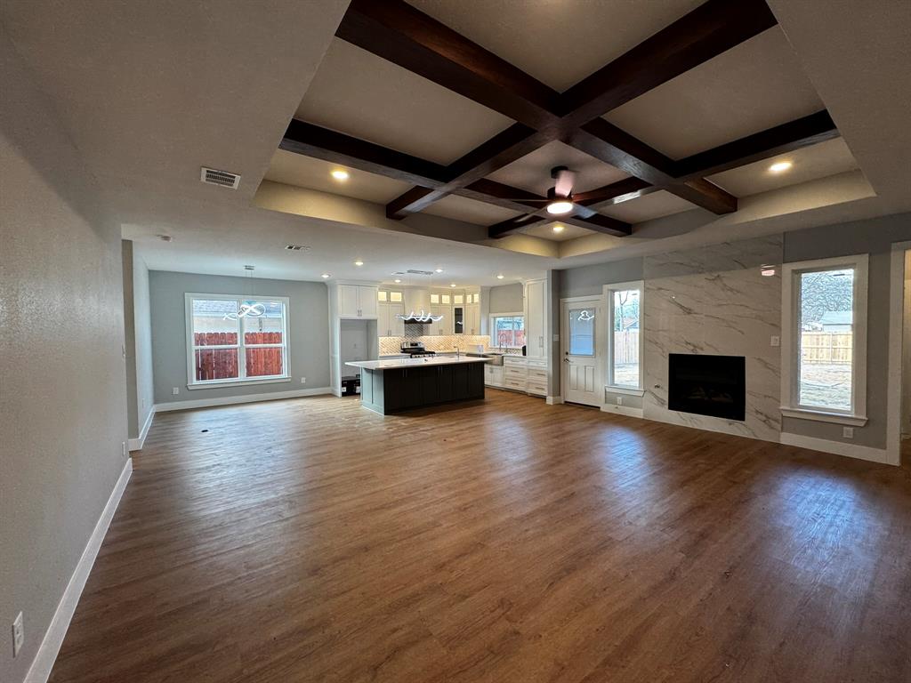 2533 Jonesboro Avenue Dallas, TX 75228 - Photo 4 of 27 a view of empty room with wooden floor and fireplace