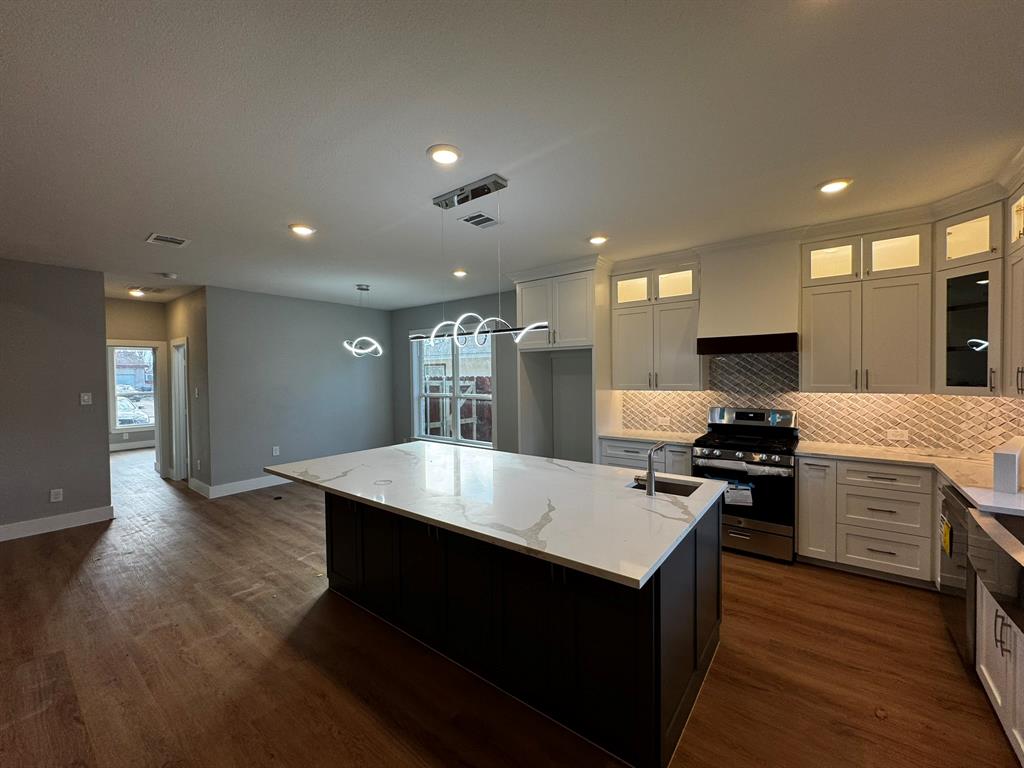 2533 Jonesboro Avenue Dallas, TX 75228 - Photo 6 of 27 a large kitchen with stainless steel appliances a large counter top a stove and a refrigerator