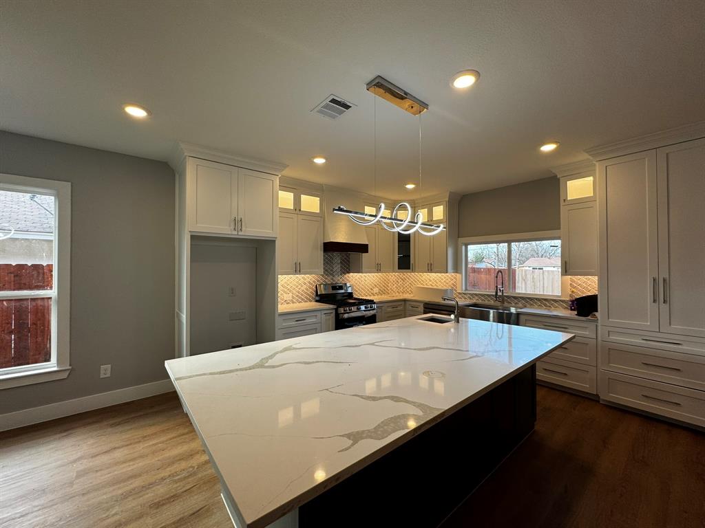 2533 Jonesboro Avenue Dallas, TX 75228 - Photo 7 of 27 a large kitchen with a large counter top appliances and cabinets