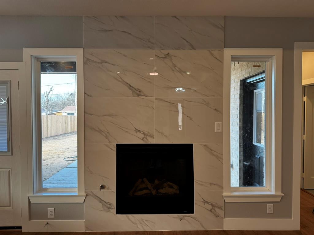 2533 Jonesboro Avenue Dallas, TX 75228 - Photo 8 of 27 a living room with a fireplace and a large window