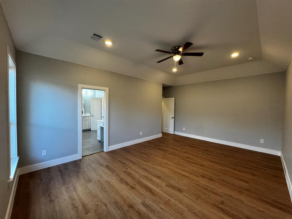 2533 Jonesboro Avenue Dallas, TX 75228 - Photo 9 of 27 a view of empty room with wooden floor and fan
