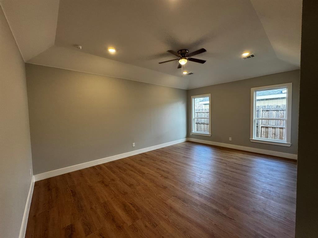 2533 Jonesboro Avenue Dallas, TX 75228 - Photo 10 of 27 a view of empty room with wooden floor and fan