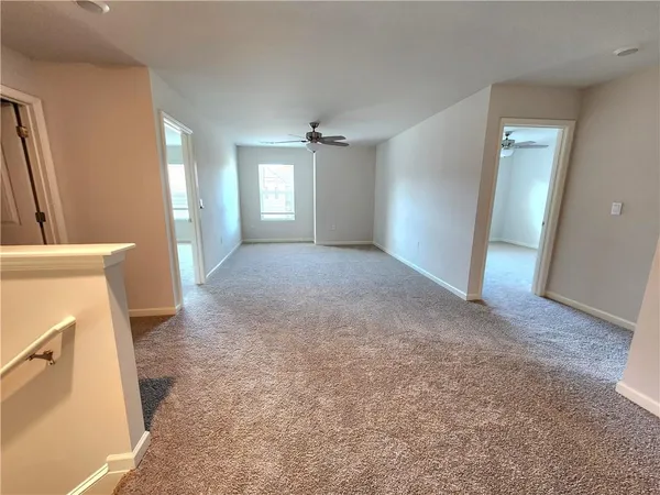 an empty room with windows and cabinet