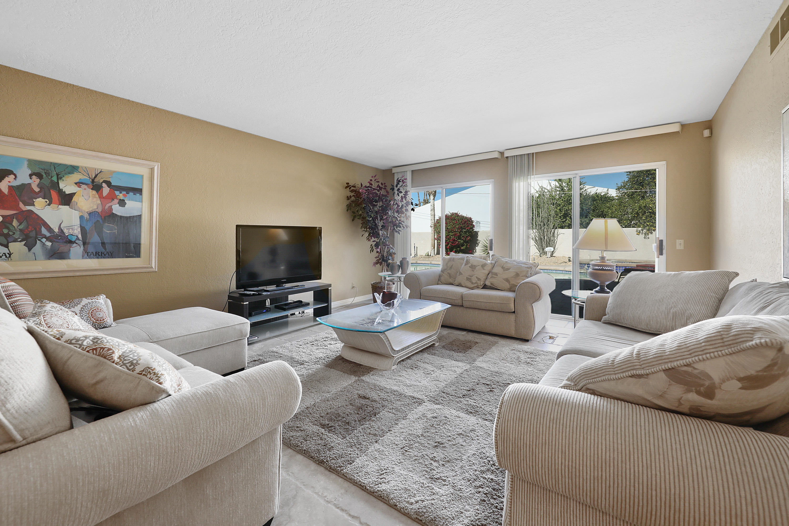 78950 Starlight Lane Bermuda Dunes, CA 92203 - Photo 4 of 32 a living room with furniture and a flat screen tv
