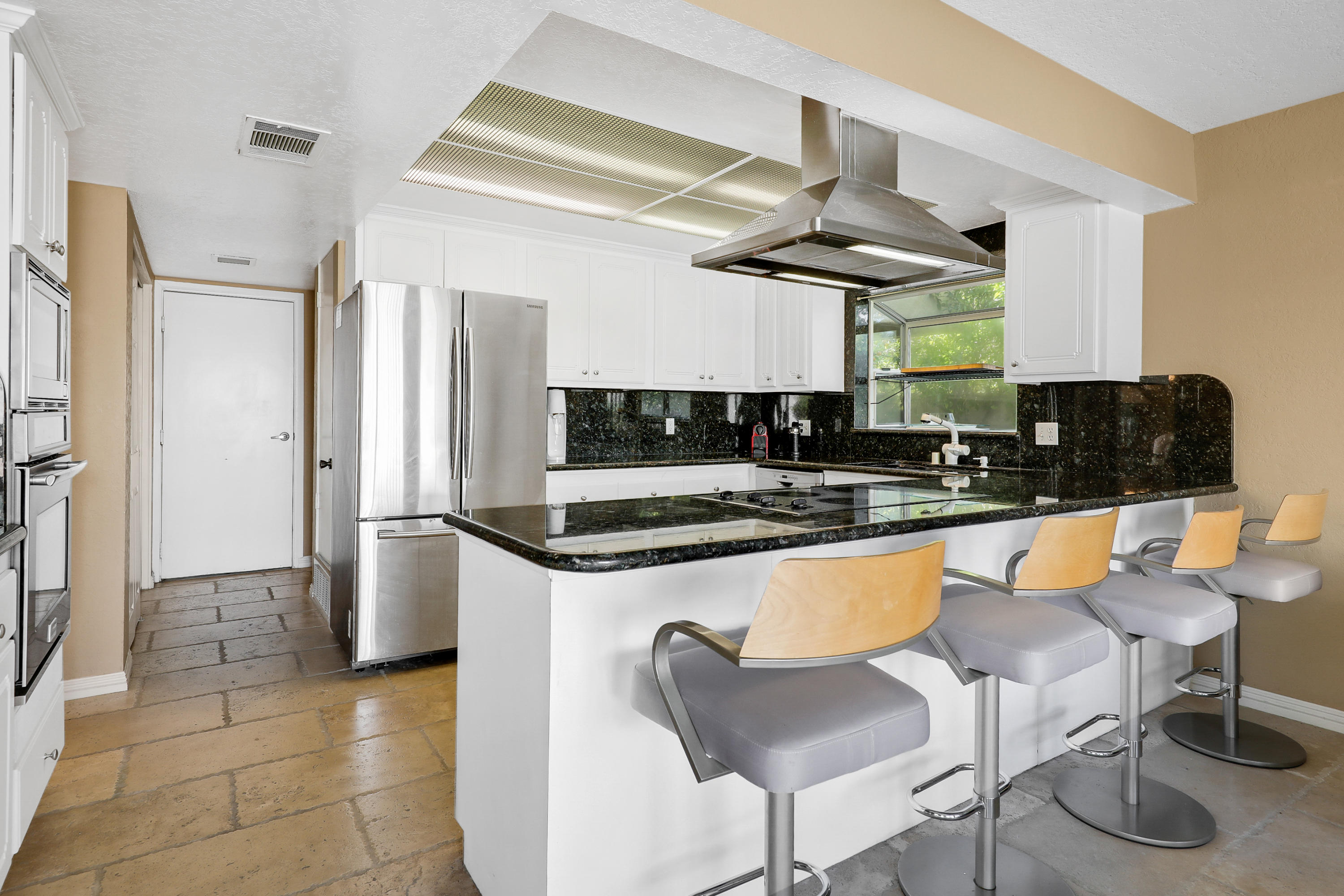 78950 Starlight Lane Bermuda Dunes, CA 92203 - Photo 8 of 32 a kitchen with stainless steel appliances granite countertop a sink and a refrigerator
